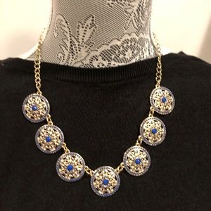 Women’s gold and blue necklace.